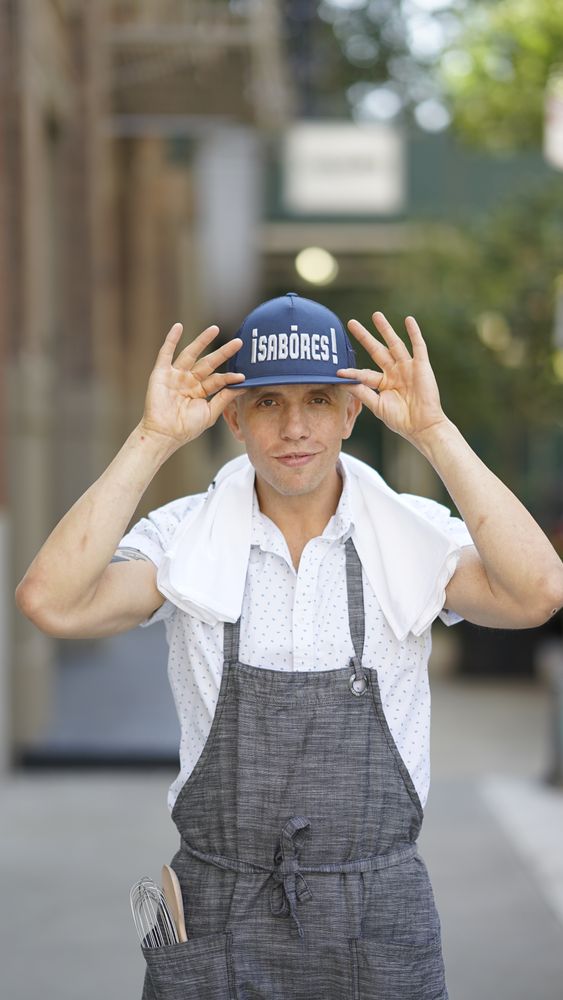 Chef Ronaldo Linares in chef&rsquo;s apron on a city street